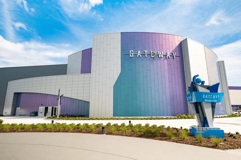 facade with white, purple and blue panels and sign