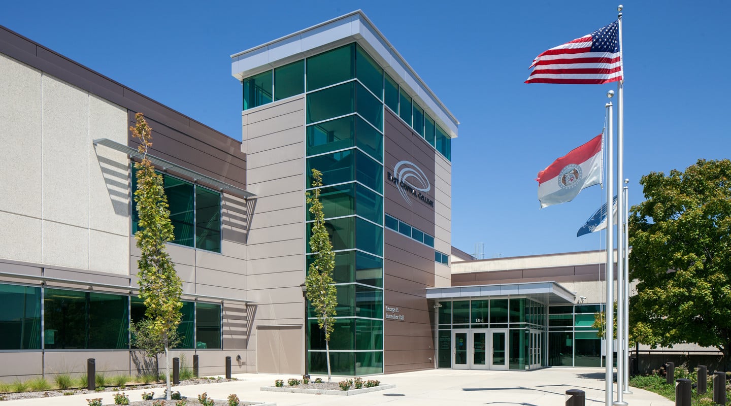 front entrance with tower and flags